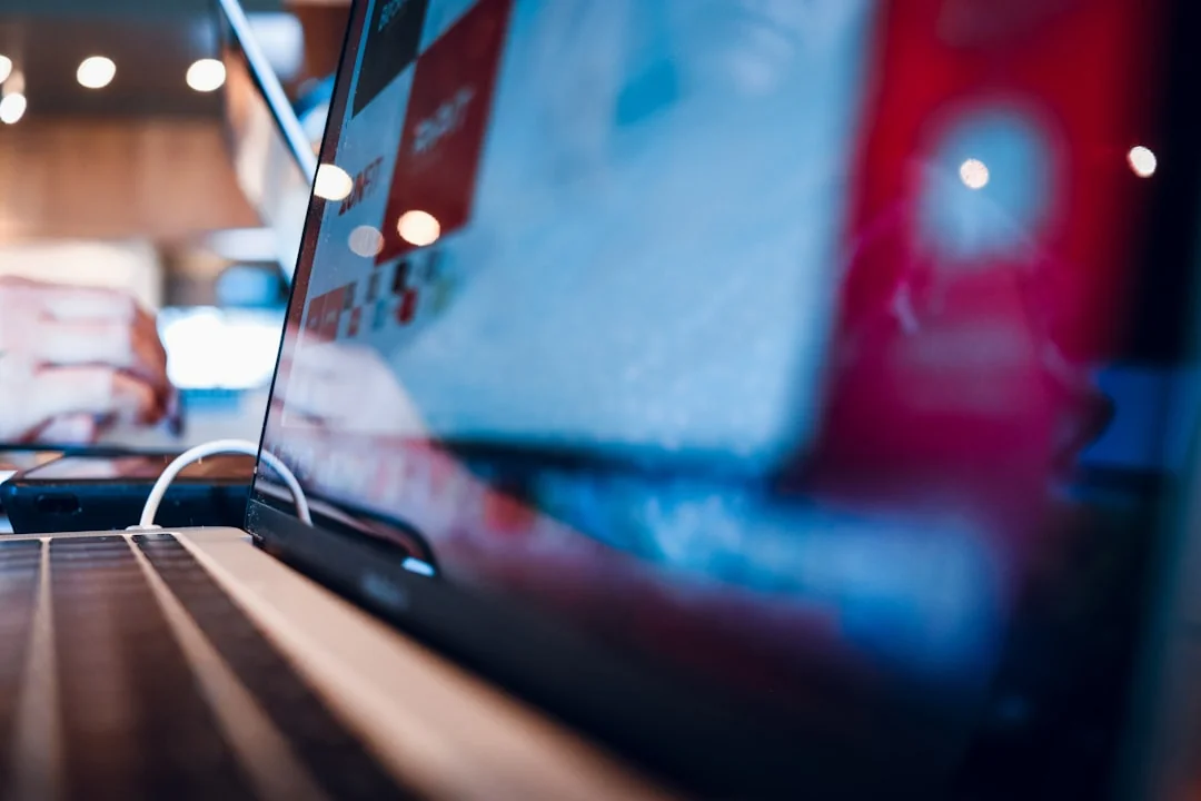 Close-up of a smartphone with a stylus on a bright red surface, showcasing modern technology.
